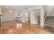 Open-concept living space with hardwood floors and staircase access at 1030 Jersey St # 1, Denver, CO 80220