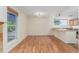 Open living area with hardwood floors and kitchen counter seating at 1030 Jersey St # 1, Denver, CO 80220