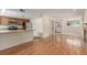 Open living area with hardwood floors, kitchen access, and a front door at 1030 Jersey St # 1, Denver, CO 80220