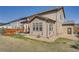 Spacious backyard view featuring a patio area, privacy fence and well-maintained green grass at 77 N Jackson Gap Way, Aurora, CO 80018