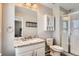 Clean bathroom with granite counters, a glass door shower, and neutral gray wall paint at 77 N Jackson Gap Way, Aurora, CO 80018
