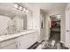 Bathroom featuring white cabinetry, a granite countertop, and a shower and walk-in closet at 77 N Jackson Gap Way, Aurora, CO 80018