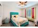 Cozy bedroom with a bright color scheme, a ceiling fan, and stylish matching decor at 77 N Jackson Gap Way, Aurora, CO 80018