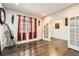Bright dining room with hardwood floors, large windows, and french doors leading to another room at 77 N Jackson Gap Way, Aurora, CO 80018