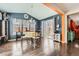 Elegant dining area featuring a chandelier, hardwood floors, and sliding glass doors to the backyard at 77 N Jackson Gap Way, Aurora, CO 80018
