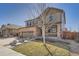 Inviting two-story house with stone accents, covered porch, lush lawn, and a convenient two-car garage at 77 N Jackson Gap Way, Aurora, CO 80018