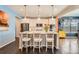 Bright and airy kitchen featuring a center island, stainless steel appliances, and a view of the dining area at 77 N Jackson Gap Way, Aurora, CO 80018