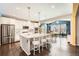 Open-concept kitchen featuring a large island with seating, stainless steel appliances, and hardwood floors at 77 N Jackson Gap Way, Aurora, CO 80018
