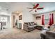Comfortable living room with a sectional sofa, a ceiling fan, and natural light from the window at 77 N Jackson Gap Way, Aurora, CO 80018