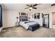 Main bedroom with carpeting, ceiling fan, upholstered headboard and bench with decoratively painted walls at 77 N Jackson Gap Way, Aurora, CO 80018