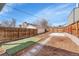 Spacious backyard featuring artificial turf, a concrete patio, and privacy fencing at 1267 Quitman St, Denver, CO 80204