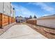 Spacious backyard featuring a concrete patio, wood fence, and low maintenance landscaping at 1267 Quitman St, Denver, CO 80204