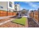 Yard featuring a concrete patio, synthetic turf, and wood fencing at 1267 Quitman St, Denver, CO 80204