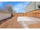 Backyard with concrete patio, decorative mulch, and wood fencing at 1267 Quitman St, Denver, CO 80204