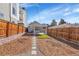 Backyard with concrete patio, small turf area, and privacy fencing at 1267 Quitman St, Denver, CO 80204