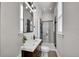 Modern bathroom featuring sleek vanity, glass-enclosed shower, and contemporary lighting at 1267 Quitman St, Denver, CO 80204