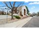 This two-story condo building features inviting stairs, a balcony, and landscaping for a warm welcome at 9677 W Chatfield Ave # E, Littleton, CO 80128