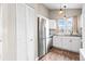 Modern kitchen with stainless steel refrigerator and granite countertops at 9677 W Chatfield Ave # E, Littleton, CO 80128