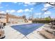 Seasonal pool area with lounge chairs, fencing, nearby clubhouse and sunny skies at 9677 W Chatfield Ave # E, Littleton, CO 80128
