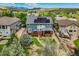 Aerial view of backyard deck, landscape and a home featuring solar panels in a neighborhood with mountain views at 19105 Eagle Ridge Dr, Golden, CO 80401