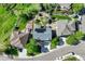 Aerial view of a home with solar panels, a fenced backyard, and a well-maintained landscaped yard in a quiet neighborhood at 19105 Eagle Ridge Dr, Golden, CO 80401