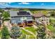 Aerial view of backyard and exterior, including solar panels on the roof, a multi-level deck and a well-kept backyard at 19105 Eagle Ridge Dr, Golden, CO 80401