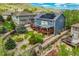 Aerial view showing the house with backyard deck, stone drainage feature, landscaping and solar panels at 19105 Eagle Ridge Dr, Golden, CO 80401