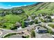 Aerial view of a neighborhood with lush green spaces and picturesque mountain views surrounding the residences at 19105 Eagle Ridge Dr, Golden, CO 80401