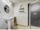 Modern bathroom featuring a pedestal sink, tile floors, and a glass-enclosed shower at 19105 Eagle Ridge Dr, Golden, CO 80401