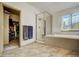 Bright bathroom showing a glass-enclosed shower, soaking tub, and walk-in closet with ample storage space at 19105 Eagle Ridge Dr, Golden, CO 80401
