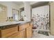 Bathroom features a single vanity, a patterned shower curtain, and tile flooring at 19105 Eagle Ridge Dr, Golden, CO 80401