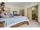 Spacious bedroom featuring an ornate wooden bed frame with attached ensuite bathroom and closet at 19105 Eagle Ridge Dr, Golden, CO 80401