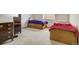 Bedroom features twin beds, built-in drawers, a window, and a wooden dresser at 19105 Eagle Ridge Dr, Golden, CO 80401
