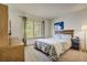 Cozy bedroom featuring a queen-sized bed, natural light from the window, and a coordinating dresser and nightstand at 19105 Eagle Ridge Dr, Golden, CO 80401