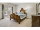 Bright bedroom features a decorative wooden bed frame, a sliding glass door and neutral-colored walls at 19105 Eagle Ridge Dr, Golden, CO 80401