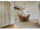 Cozy dining room with a classic wood table, six chairs, and a charming window at 19105 Eagle Ridge Dr, Golden, CO 80401