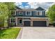 Charming two-story home with stone accents, a well-manicured lawn, and an attached three-car garage at 19105 Eagle Ridge Dr, Golden, CO 80401
