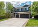 Beautiful home featuring a spacious driveway, lush greenery, and an attached three-car garage at 19105 Eagle Ridge Dr, Golden, CO 80401