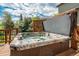 Backyard deck features a hot tub with privacy screening and lush landscaping at 19105 Eagle Ridge Dr, Golden, CO 80401