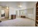 Expansive living room offers ample space, neutral walls, and wooden decor and shelving at 19105 Eagle Ridge Dr, Golden, CO 80401