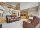 Open-concept living room with a staircase, comfortable seating, and a view of the kitchen at 19105 Eagle Ridge Dr, Golden, CO 80401