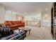 Spacious living room featuring hardwood railing, plush sofas, neutral carpet, and a classic dark-wood coffee table at 19105 Eagle Ridge Dr, Golden, CO 80401