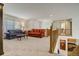 Loft-style living room with wood railing, plush sofas, neutral carpet, and staircase with railing at 19105 Eagle Ridge Dr, Golden, CO 80401