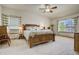 Spacious main bedroom with large windows, ceiling fan, and neutral carpet at 19105 Eagle Ridge Dr, Golden, CO 80401