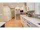 Bright kitchen featuring stainless steel appliances, white cabinets, and elegant countertops at 345 S Ogden St, Denver, CO 80209