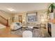 Cozy living room features a fireplace, large window, neutral tones and hardwood floors at 345 S Ogden St, Denver, CO 80209