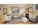 Bright living room with fireplace, neutral furniture, a large window, and hardwood floors at 345 S Ogden St, Denver, CO 80209