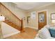 Inviting living room with hardwood floors, staircase, front door and neutral tones at 345 S Ogden St, Denver, CO 80209