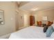 Spacious bedroom with hardwood floors, neutral walls, and comfortable seating arrangement at 345 S Ogden St, Denver, CO 80209