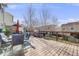 Spacious deck with outdoor furniture, umbrella and barbecue overlooking the backyard at 5559 S Quemoy Cir, Aurora, CO 80015
